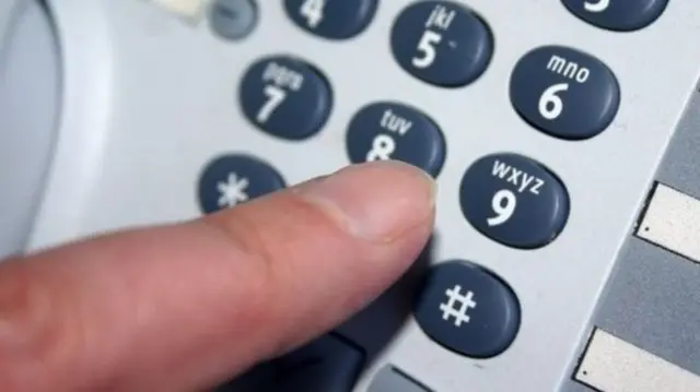 A finger pressing a button on a phone