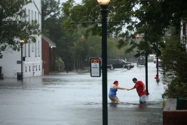 Two people in flooded street