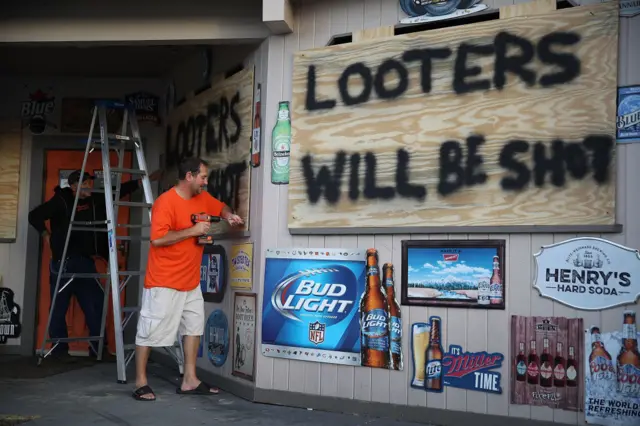 'looters will be shot' sign