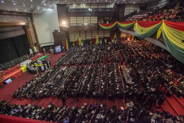 Packed hall of mourners