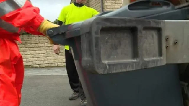 A man emptying a bin