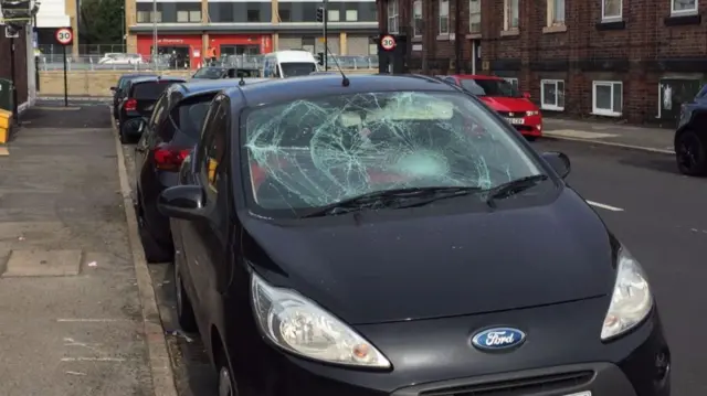 Window smashed on a black car