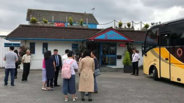 Chinese tourists visiting a fish and chip shop