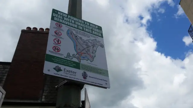 A PSPO sign stands near Musgrave Row toilets in Exeter City Centre