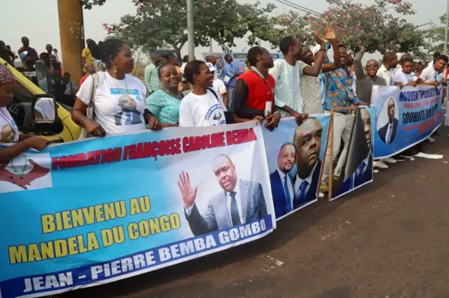 Supporters of Congolese opposition leader Jean-Pierre Bemba chant slogans outside the N"djili International Airport as he arrives in Kinshasa, Democratic Republic of Congo August 1,