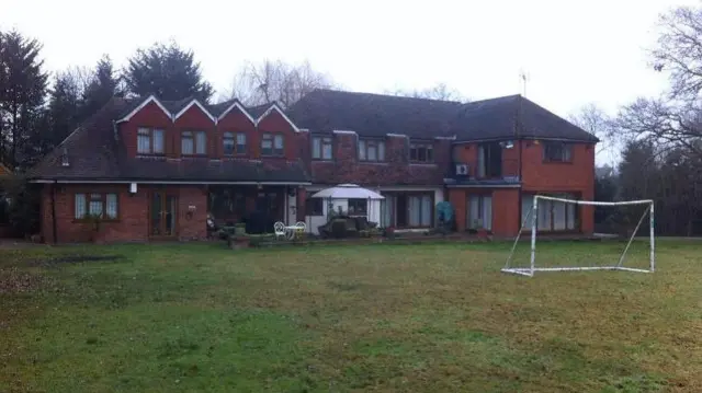 A house with a garden and football goalposts