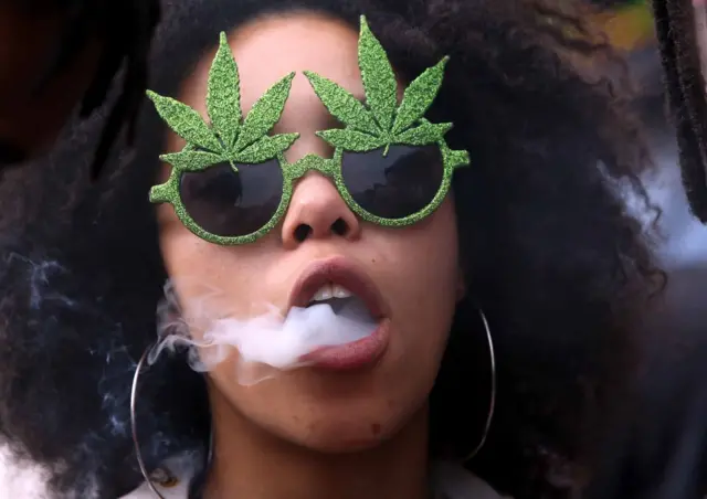 A woman is seen blowing smoke during the annual Cape Town Cannabis March through the CBD on May 06, 2017 in Cape Town, South Africa.