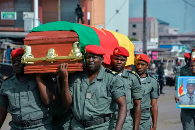 Soldiers carry a coffin