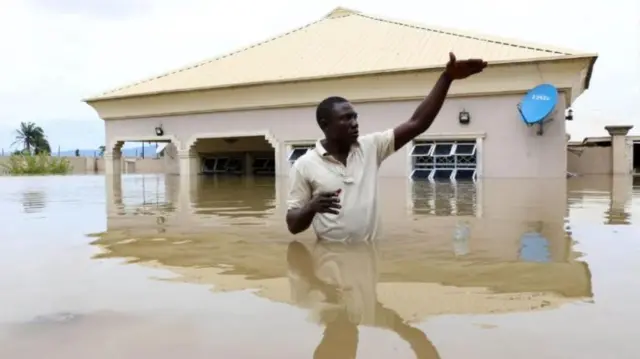 A man gestures next to his flooded house following heavy rain near the Nigerian town of Lokoja, in Kogi State, on September 14, 2018. A man gestures next to his flooded house following heavy rain near the Nigerian town of Lokoja, in Kogi State, on September 14, 2018.