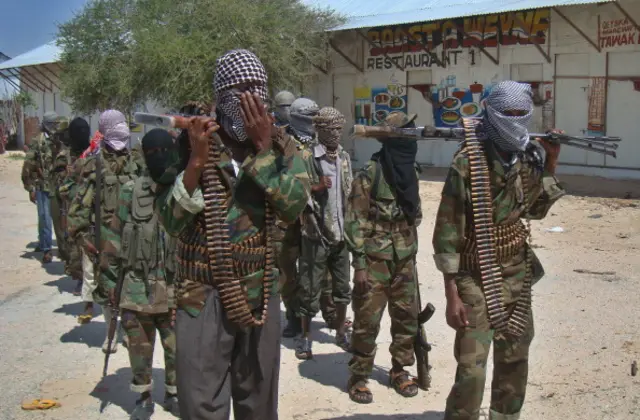 Al-Qaeda linked al-shabab recruits walk down a street on March 5, 2012 in the Deniile district of Somalian capital, Mogadishu