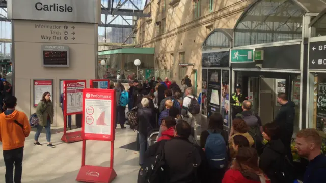 People queuing for replacement buses at Carlisle railway station