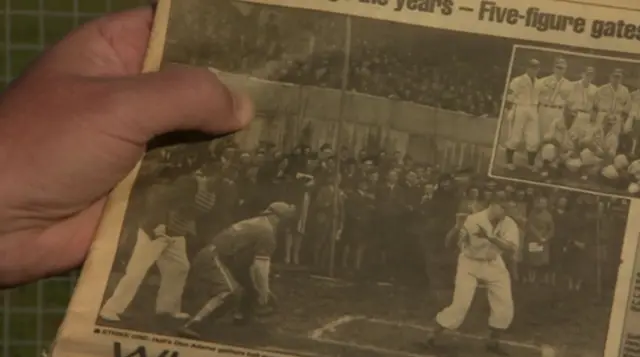 Kevin McAdam holding a newspaper clipping