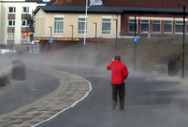 Strong winds blow sand across the seafront at Troon Beach in Ayrshire