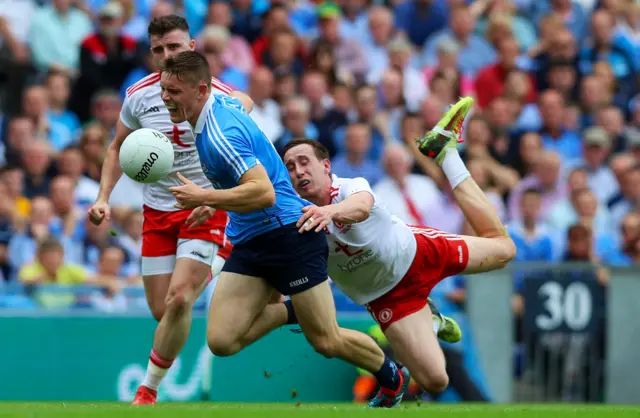 Con O'Callaghan is the subject of an attempted tackle by Colm Cavanagh