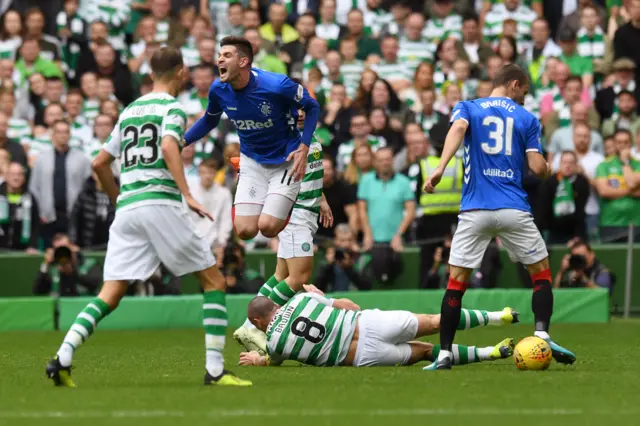 Kyle Lafferty jumps to avoid a late challenge from Celtic captain Scott Brown