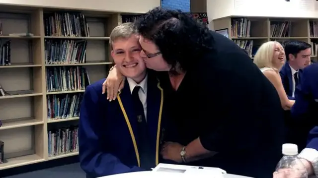 Fraser, a pupil at Greenfaulds High School in Cumbernauld, gets a kiss from his mum after getting five As