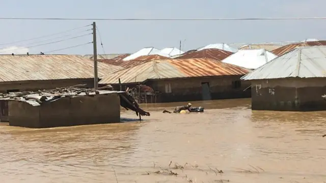 Woman with material saved from the floods