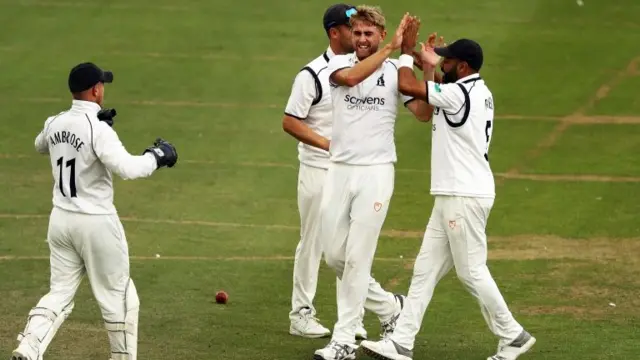 Warwickshire celebrating taking a wicket