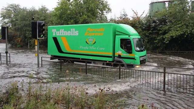 A lorry drives through the water