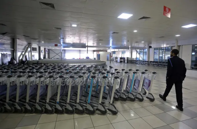 A security man walks inside Mitiga airport the day after militiamen attacked it in an attempt to free colleagues held at a jail there, on the eastern outskirts of the Libyan capital Tripoli, on January 16, 2018.