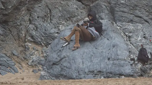 Harry Richardson sitting on a rock