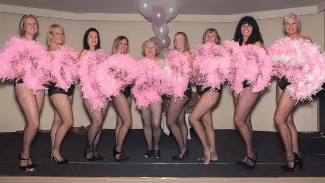 Dare to Bare women in underwear with pink feathers