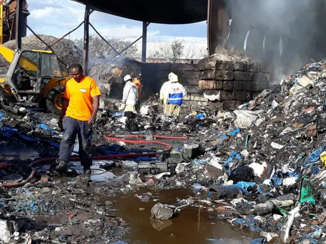 Charred remains of piles of rubbish