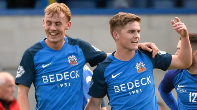 Glenavon players celebrate victory over Crusaders at Mourneview Park