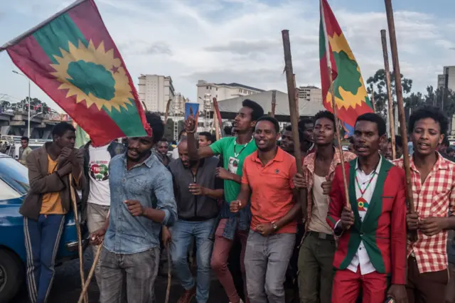 People celebrate ahead of the return of a formerly banned anti-government group, the Oromo Liberation Front (OLF), in the Ethiopian capital Addis Ababa on September