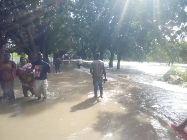 People standing in flood water