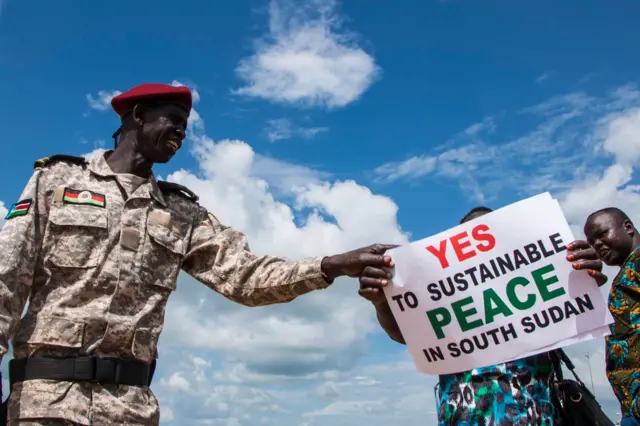 South Sudanese wait for the arrival of South Sudan's President at Juba International Airport in Juba on June 22, 2018