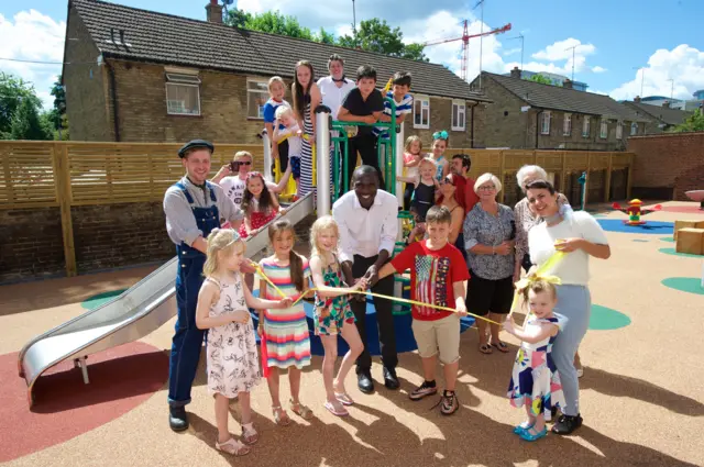 Peabody neighbourhood managers Kayode Ogundamisi with residents opening a new Peabody-funded playground in Hammersmith