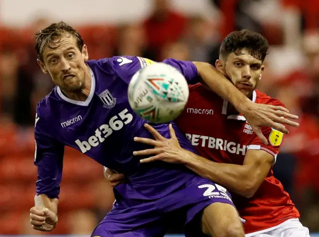 Tobias Figueiredo tussles with Peter Crouch