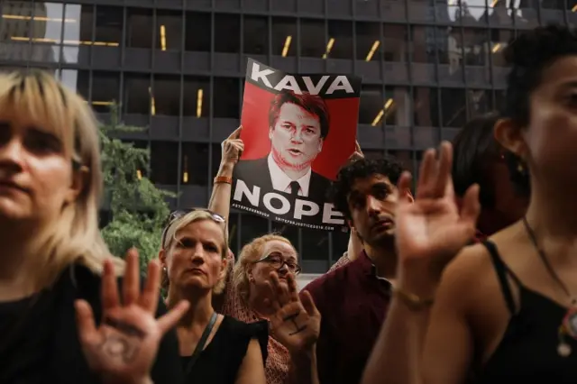 Protesters with sign saying KAVA NOPE