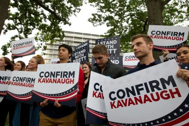 Kavanaugh supporters holding "Confirm Kavanaugh"