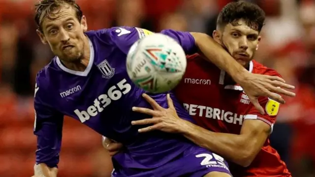 Stoke City"s Peter Crouch in action with Nottingham Forest"s Tobias Figueiredo