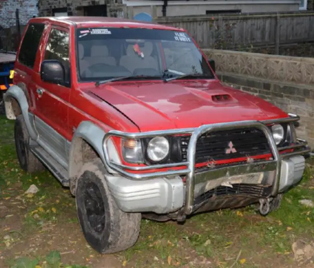 A red Mitsubishi 4x4