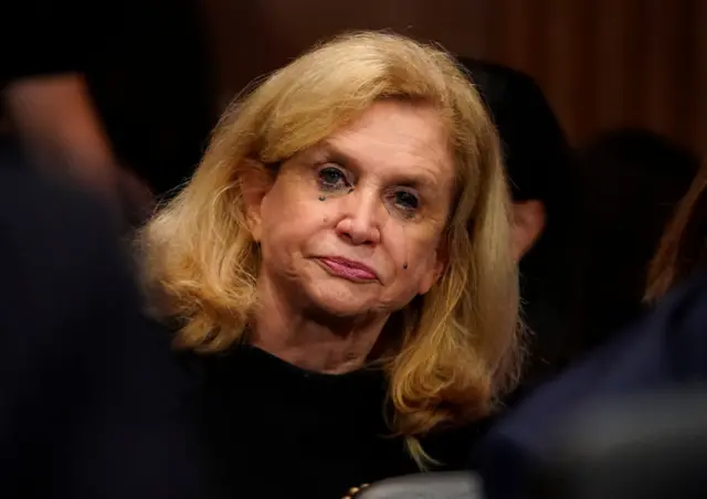 New York Democratic Congresswoman Carolyn Maloney's makeup appears to run as she watches the hearing.