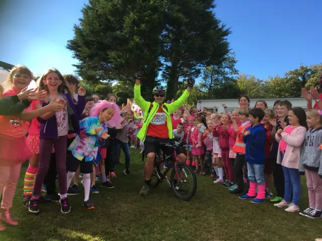 Pete Williams arrives at St Hilary’s school on his daughter's bike