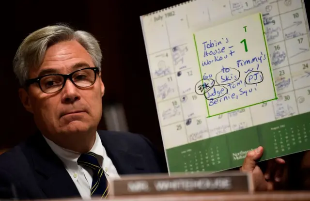 Senate Judiciary Committee member Senator Sheldon Whitehouse (D-RI) points out names on the high school calender of Brett Kavanaugh during a markup hearing on Capitol Hill. i