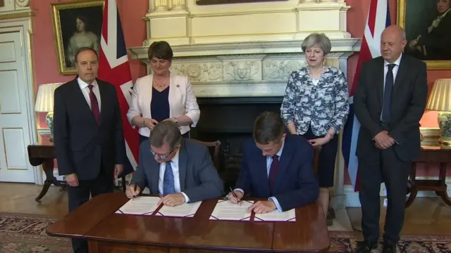 Senior DUP and Conservative Party figures sign their confidence and supply deal