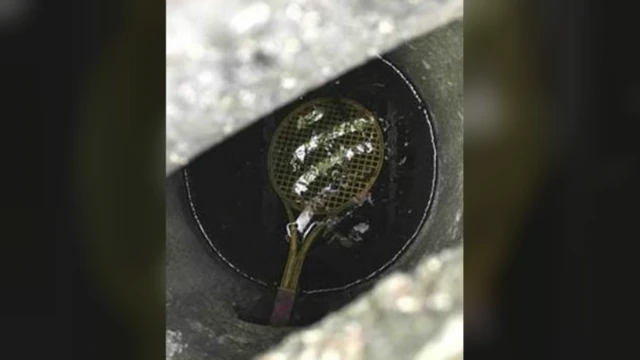 Tennis racquet in drain