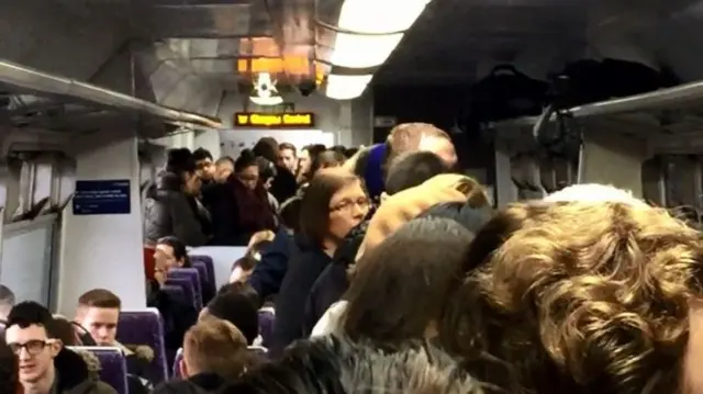 Passengers on a packed morning train from Barrhead to Glasgow Central