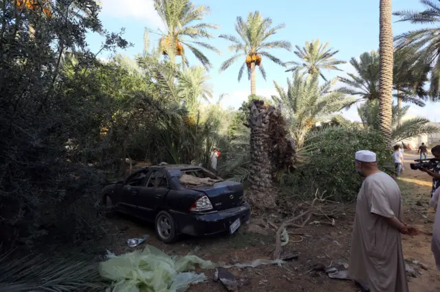 Libyans gather at the site of where a mortar shell landed in the capital Tripoli on August 30, 2018