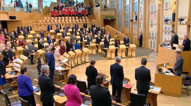 MSPs standing in chamber