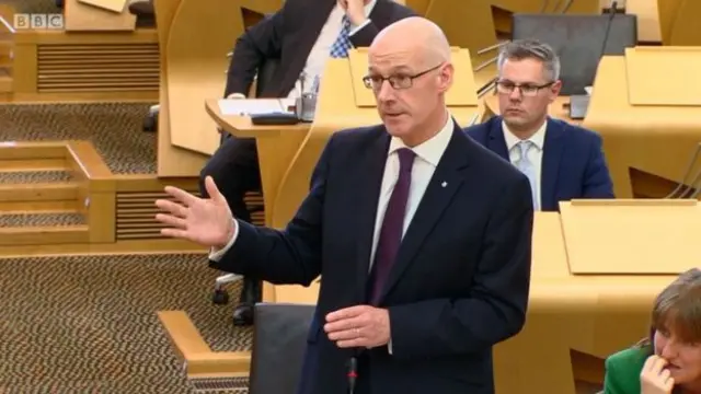 John Swinney told MSPs that he was committed to the tests "at all stages"