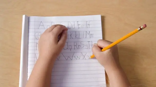 Child writing alphabet