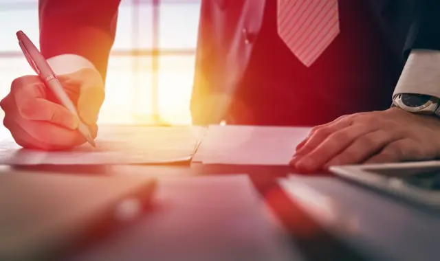 A man signing a document