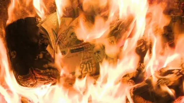 Burning £20 notes