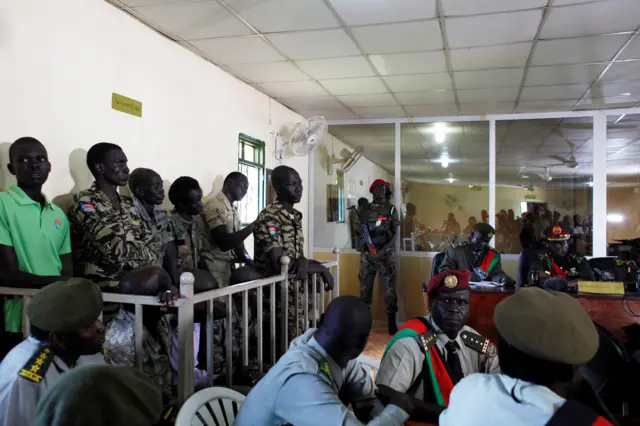 South Sudanese soldiers stand during their sentencing over the rape of foreign aid workers and the murder of a local journalist in an assault on the Terrain Hotel in the capital Juba in 2016